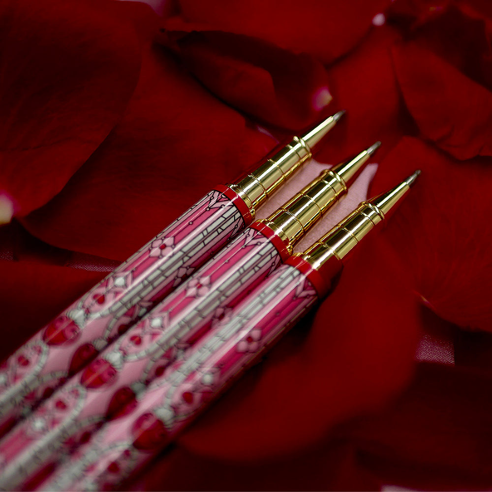 Bite Me Pen- The Quirky Cup Collective - Stained Glass Inspired Pen Design with 'Bite me' engraved on the pen clip. Pen sits on a bed of red rose petals. 