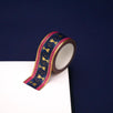 A close up of the Blood Spilled washi tape by The Quirky Cup Collective. The fantasy book inspired washi tape design is pink, blue with gold detailing with a goblet motif.