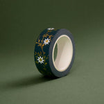 The Sage green variation of the Botanica Literati washi tape. The classic book inspired washi tape design is shown on a green background and features a a vine covered in tiny flowers and leaves in shades of dark green, sage green, white and foiled gold.