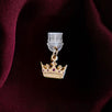An detail shot of the gold Gilded Heir dust plug on a deep red fabric background. The fantasy aesthetic kindle decor sees the dust plug feature a small crown motif with red details.