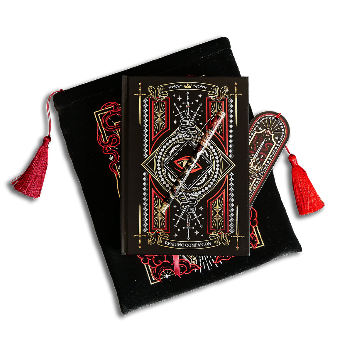 The Destiny Awaits Reading companion bundle shows a reading companion, pen, bookmark and embroidered book sleeve stacked on top of each other. The romantasy inspired products are all black with red, white and gold detailing and all feature a design with a motif of a dragon eye, swords and a crown.