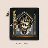 Decorated Kobo Libra with a set of ereader accessories that are gold and feature dragons, moons and celestial themes inside a cathedral window