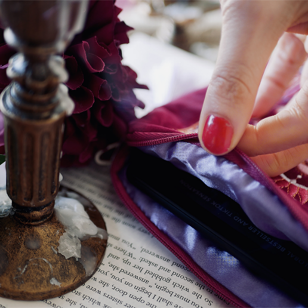 Iridescence Kindle & Reader Sleeve - The Quirky Cup Collective - Pink velvet sleeve with stained glass embroidered design on a background of books, flowers and candles