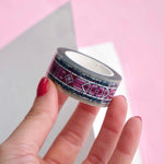 Clear washi tape with a pink panels and green foliage