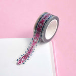 Clear washi tape with a pink panels and green foliage