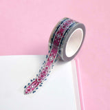 Clear washi tape with a pink panels and green foliage