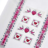 Clear washi tape with a pink panels, hearts and birds, and green foliage