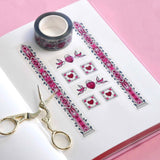 Clear washi tape with a pink panels, hearts and birds, and green foliage