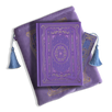 The wisteria journal bundle from the classic book inspired Literati collection. This soft lilac variation includes a book sleeve, journal, pen and bookmark from the collection. All share a slightly Victorian book inspired motif in shades of gold, pink, purple and blue. The foiled journal, pen and bookmark feature intricate gold foiling while the velvet book sleeve is embroidered. The sleeve and bookmark also feature light blue tassels.