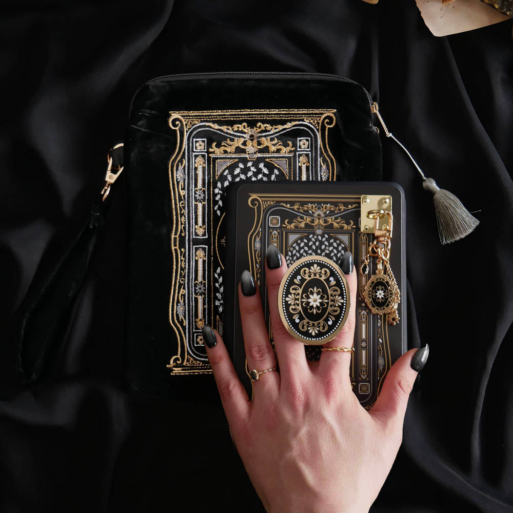The Black literati eReader decor bundle. The classic book inspired kindle set-up includes a charmlet, clingie, eReader sleeve, dust plug and eReader sticker insert all in shades of black, gold and white with designs inspired by classic literary aesthetic. 
