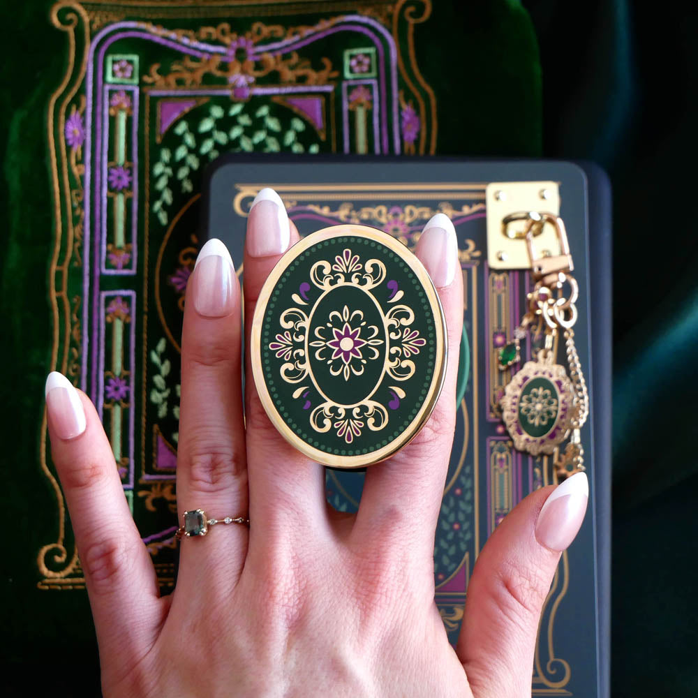 The forest green literati eReader decor bundle. The classic book inspired kindle aesthetic includes a charmlet, clingie, eReader sleeve, dust plug and eReader sticker insert all in shades of black, green and purple with designs inspired by classic victorian aesthetic. 
