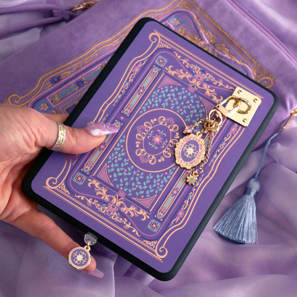 An image of the wisteria literati eReader decor bundle. The set features an eReader sleeve, eReader sticker insert, charmlet and dust plug all in the same light purple colour with pastel pink, purple and blue detailing alongside gold foil and embroidery.