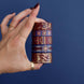 Five rolls of washi tape with red and blue backgrounds with flowers and gold foil