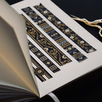 Washi tapes with a black background with white and gold flowers and gold foil