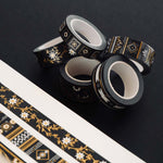 Washi tapes with a black background, white and gold flowers and gold foil