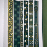 The full set of the Sage green variation of the Literati washi tape by The Quirky Cup Collective. The classic book inspired washi tape designs are shown in strips on a journal page and feature classical book inspired designs and ornamentation in shades of dark green, sage green, white and foiled gold.