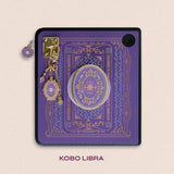 Decorated Kobo Libra with a set of aesthetic ereader accessories that are purple, pink and blue with gold hardware