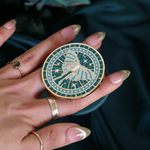 teal kindle grip depicting a luna moth with celestial accents by the quirky cup collective