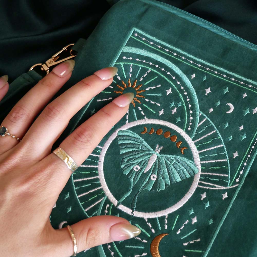 Embroidered Luna moth eReader sleeve in teal with zipper closure, satin lining, wrist strap and back pocket for Kindle or Kobo. Created by The Quirky Cup Collective