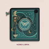 Decorated Kobo Libra with a set of aesthetic ereader accessories. Theme is celestial luna moth and includes a luna moth, celestial elements, sun, moons and stars. Colours are teal, white and gold. 