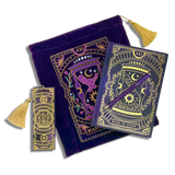 bundle of purple stationery items on a plain background. Items are a book sleeve, journal, pen and bookmark. Design features an hourglass with celestial and botanical inspired design. 