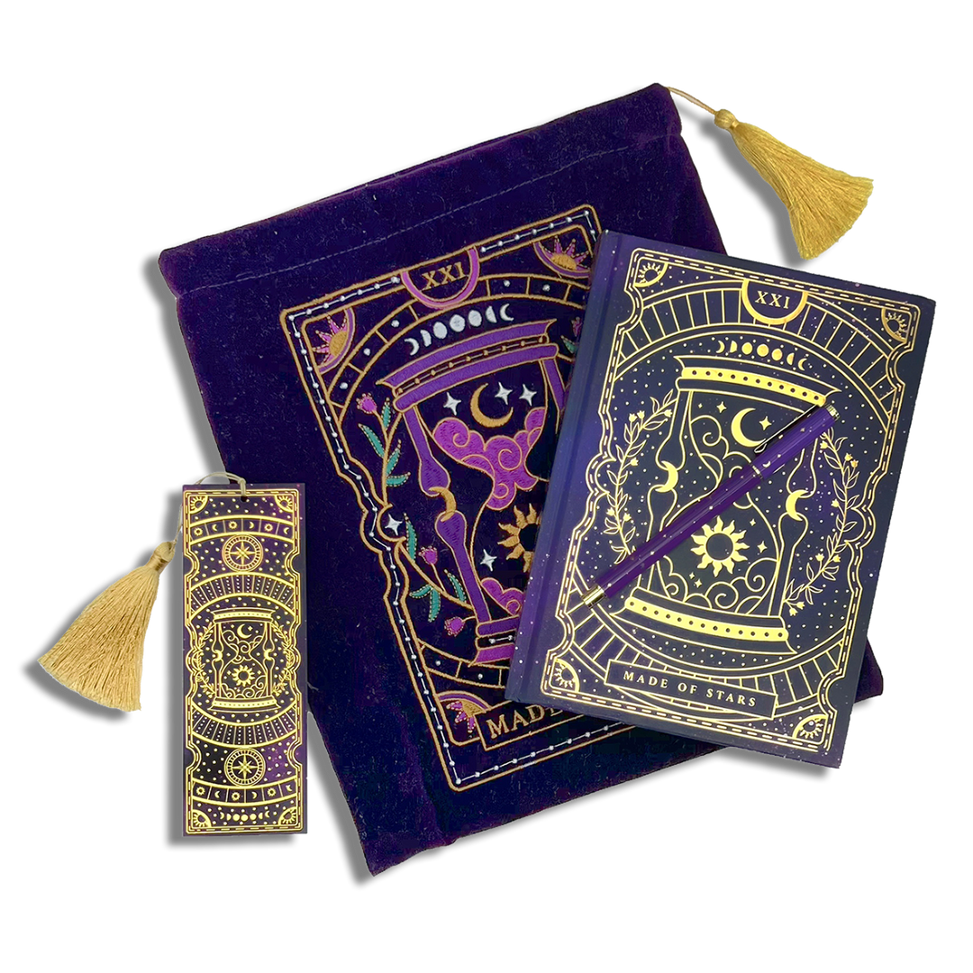 bundle of purple stationery items on a plain background. Items are a book sleeve, journal, pen and bookmark. Design features an hourglass with celestial and botanical inspired design. 