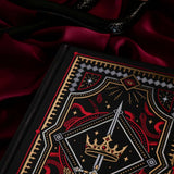 Decorative dark fantasy journal with intricate fantasy themed designs on a red fabric background