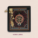 Decorated Kobo Libra with a set of aesthetic ereader accessories. Theme is dark fantasy and includes snakes, swords, crowns and dragon eyes. Colours are black, red, white and gold. 