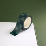 The Sage green variation of the Ornate Literati washi tape. The book inspired washi tape design is shown on the edge of a journal on a green background and features a ornate wall paper inspired design in shades of dark green, sage green and gold.