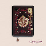 Decorated Kobo Clara with a set of aesthetic ereader accessories that are gold and wine coloured. Theme of products is Persephone and features a pomegranate, a flower, skull, daffodil, poppies and a heart. Inspired by art nouveau