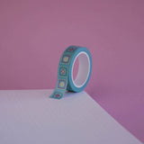 The Poetica design of French inspired washi tape as part of the Antoinette collection sits on a light pink background. The feminine washi tape features geometric flower motifs in shades of blue, pink and foil gold.