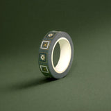 The Sage green variation of the Poetica Literati washi tape. The book inspired washi tape design is shown on a green background and features geometric flower motifs in shades of dark green, sage green and gold.