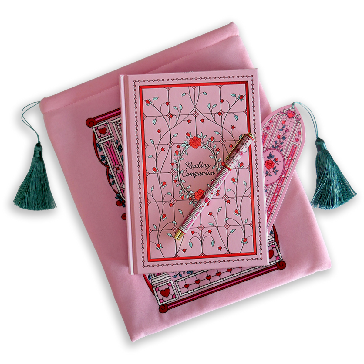 The Sugar & Spice journal bundle includes a Reading Companion Journal, bookmark, pen and book sleeve. All items are a light pink colour and feature intricate red, light pastel green and white detailing of romantic floral imagery. The Book sleeve features detailed embroidery and both the sleeve and bookmark feature a light mint green tassle.