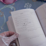 A detail of the internal pages of the french inspired reading journal in Antionette colour-way. Here the internal pages show the book rating spread with room for details, star rating and prompted thoughts.