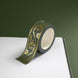 The Sage green variation of the Scriptus Literati washi tape. The classic book inspired washi tape design sits on the corner of a journal page and is shown on a green background and features a classic victorian motif of flowers and curling scrolls in shades of dark green, sage green, white and foiled gold.