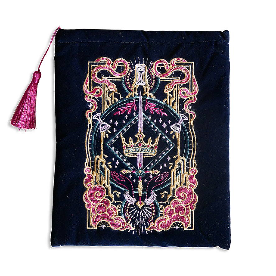 Hand holding a blue book sleeve with decorative fantasy embroidery with red background book sleeve