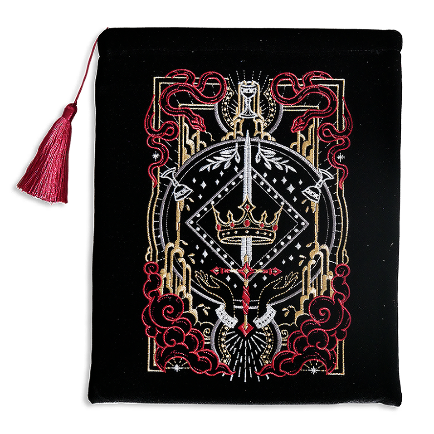 Hand holding a black book sleeve with decorative fantasy embroidery with red background book sleeve