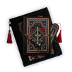 The journal bundle from the Serpents & Swords collection. This black variation includes a book sleeve, journal, pen and bookmark from the collection. All feature a design with motifs of crowns swords and snakes in shades of white, red and gold. The journal, pen and bookmark feature gold foiling while the velvet book sleeve is embroidered. The sleeve and bookmark also feature red tassels.