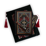 The journal bundle from the Serpents & Swords collection. This black variation includes a book sleeve, journal, pen and bookmark from the collection. All feature a design with motifs of crowns swords and snakes in shades of white, red and gold. The journal, pen and bookmark feature gold foiling while the velvet book sleeve is embroidered. The sleeve and bookmark also feature red tassels.