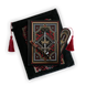 The journal bundle from the Serpents & Swords collection. This black variation includes a book sleeve, journal, pen and bookmark from the collection. All feature a design with motifs of crowns swords and snakes in shades of white, red and gold. The journal, pen and bookmark feature gold foiling while the velvet book sleeve is embroidered. The sleeve and bookmark also feature red tassels.