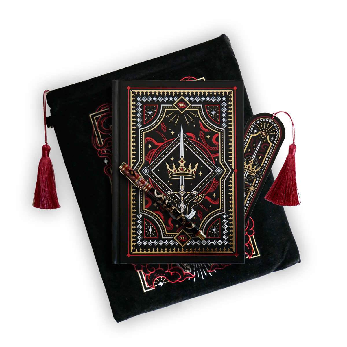 The journal bundle from the Serpents & Swords collection. This black variation includes a book sleeve, journal, pen and bookmark from the collection. All feature a design with motifs of crowns swords and snakes in shades of white, red and gold. The journal, pen and bookmark feature gold foiling while the velvet book sleeve is embroidered. The sleeve and bookmark also feature red tassels.