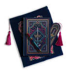 The journal bundle from the Serpents & Swords collection. This navy blue variation includes a book sleeve, journal, pen and bookmark from the collection. All feature a design with motifs of crowns swords and snakes in shades of bright pink, gold, and aqua. The journal, pen and bookmark feature gold foiling while the velvet book sleeve is embroidered. The sleeve and bookmark also feature bright pink tassels.