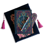 The blue Serpents & Swords bundle shows a book- sleeve, journal, pen and bookmark. Each piece features an intricate fantasy book inspired motif of a crown, sword, snakes and goblets in shades of pink, teal and gold on a deep blue background. The sleeve and bookmark also have bright pink tassles.