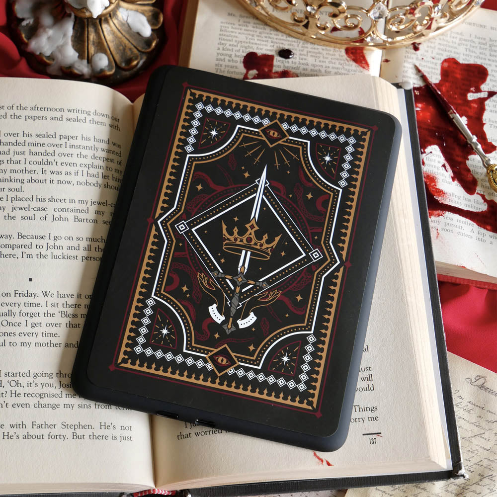The Oath Breaker Kindle Sticker Insert by The Quirky Cup Collective shows in intricate romantasy inspired design of a sword and grown surrounded by intricate snake, star and hand motifs. The mostly black design features gold, silver, red and white detailing.