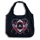 slut for smut tote bag with transparent background. Black cotton bag with red, pink, white and teal embroidery. Design features hearts, stars, leaves, scalloping and bows. 
