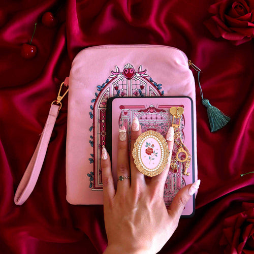 Sugar & Spice eReader decor bundle shows a light pink eReader case and sticker insert (both with red, white and green detailing) alongside a matching Clingie (similar to a pop socket!) and charmlet. The sweet romance kindle decor set sits on a red fabric background.
