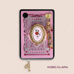 Decorated Kobo Clara with a set of aesthetic ereader accessories. Theme is spicy romance and includes sroses, eggplants, handcuffs, hearts, swallows and feathers. Colours are pink, red, teal, white and gold. 