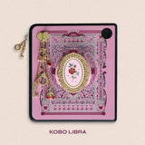 Decorated Kobo Libra with a set of aesthetic ereader accessories. Theme is spicy romance and includes sroses, eggplants, handcuffs, hearts, swallows and feathers. Colours are pink, red, teal, white and gold. 