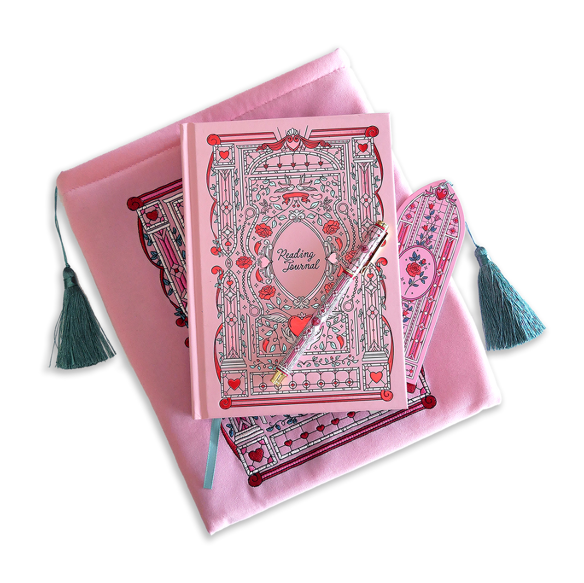 The Sugar & Spice journal bundle includes a Reading Journal, bookmark, pen and book sleeve. All items are a light pink colour and feature intricate red, light pastel green and white detailing of romantic floral imagery. The Book sleeve features detailed embroidery and both the sleeve and bookmark feature a light mint green tassle.