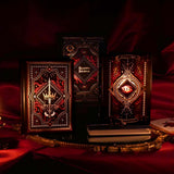 On a red fabric background sits the three journals for the Serpents & Swords collection- the journal, reading journal and reading companion. Sitting on a gold tray, the journals are all black and feature intricate red and gold foiling that show motifs of snakes, swords, dragons, crowns, goblets and more from a romantasy book aesthetic.